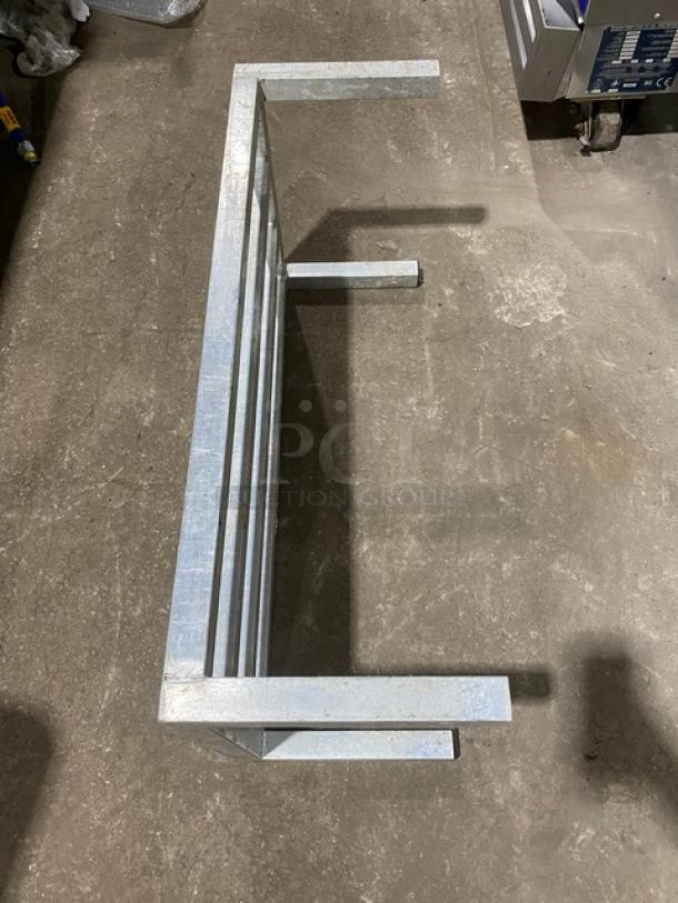 Commercial heavy-duty dunnage rack with legs, metal construction, in good condition, ideal for storage.