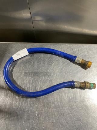 Commercial blue gas connector hose with brass fittings, in good condition. Tag labeled "64." Sturdy and flexible design.