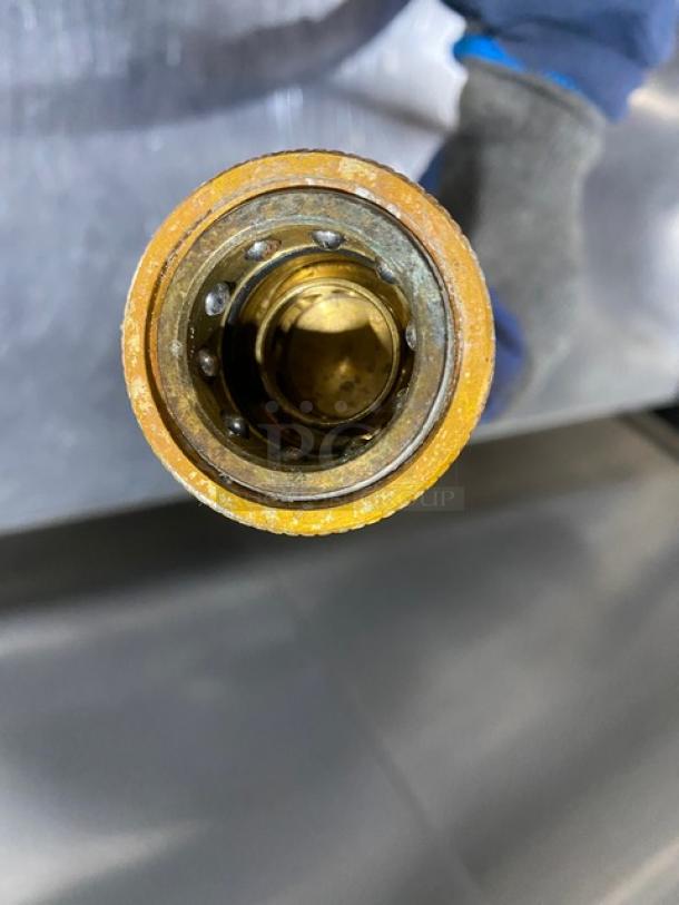 Commercial blue gas connector hose, metal fitting, used condition, suitable for industrial applications.