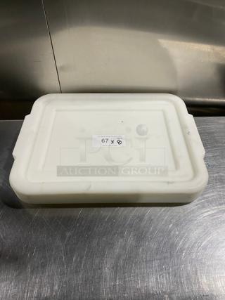 White rectangular food storage container with handled lid, viewed from above. Label reads "67 X." Item in good condition.