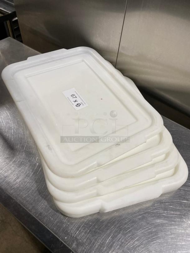 Commercial white rectangular food storage container lids with handles, stacked. Tag indicates "8X Your Bid." Clean condition.