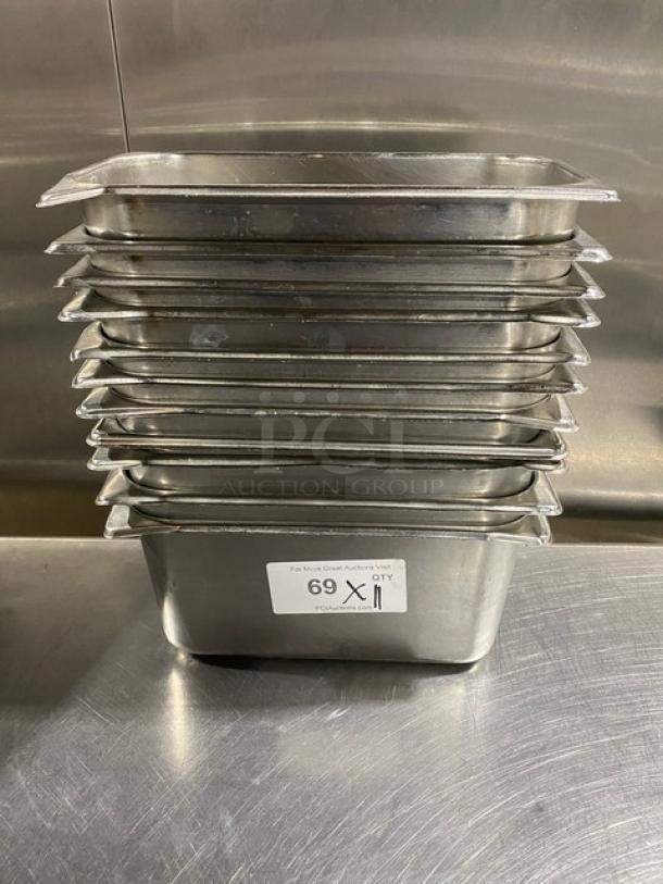 Commercial stainless steel hotel pans, stack of 11, used condition, 11" size. Label reads "69 X 11" for auction reference.