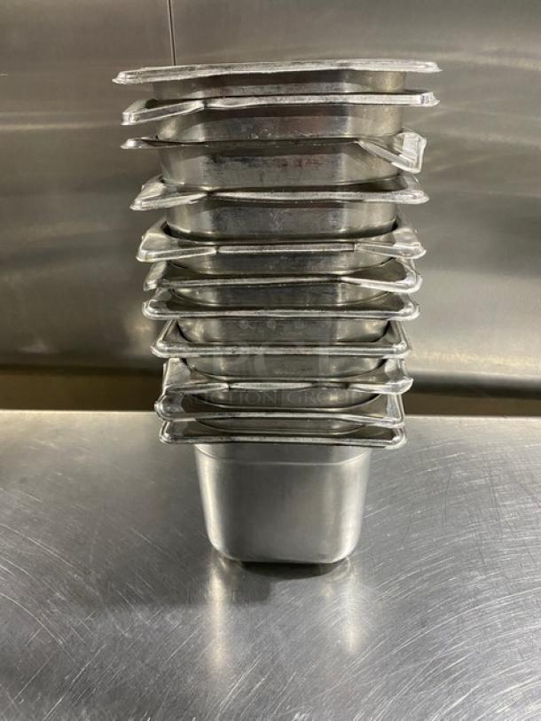 Stack of commercial stainless steel steam table pans, slightly used, reflective surface, ideal for hotel or restaurant use.