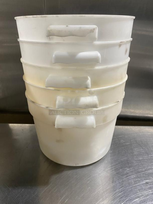 Commercial white round food storage containers, stack of five, with handles, used condition.