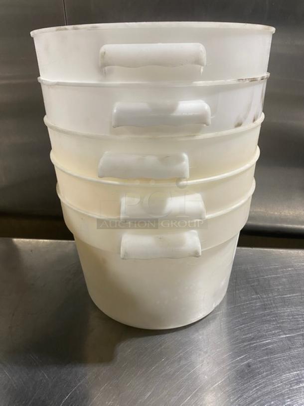 Stack of commercial white round food storage containers with handles. Used condition, five pieces, durable plastic.