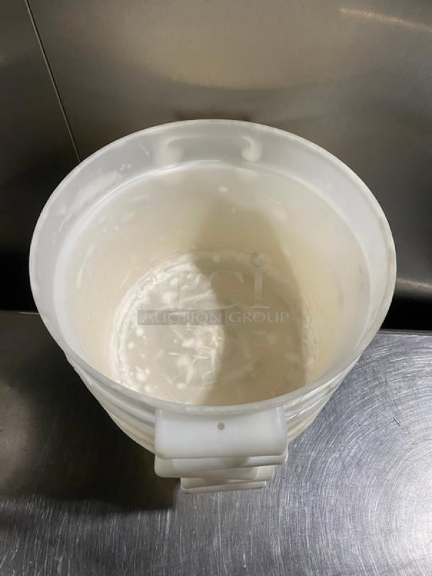 White round commercial food storage container with sturdy handles, showing minimal wear. Ideal for restaurant use.