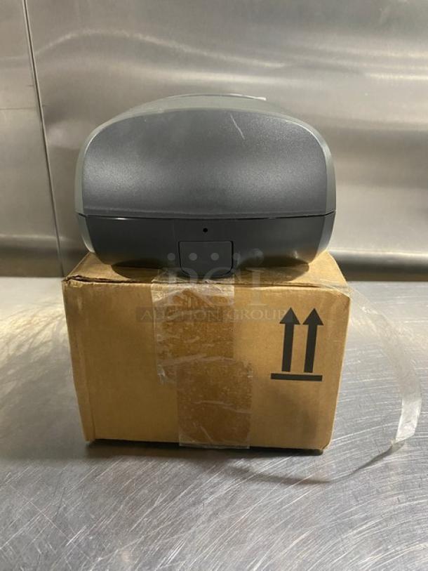 Ecolab Nexa Series touch-free hand hygiene dispenser, new, atop original box.