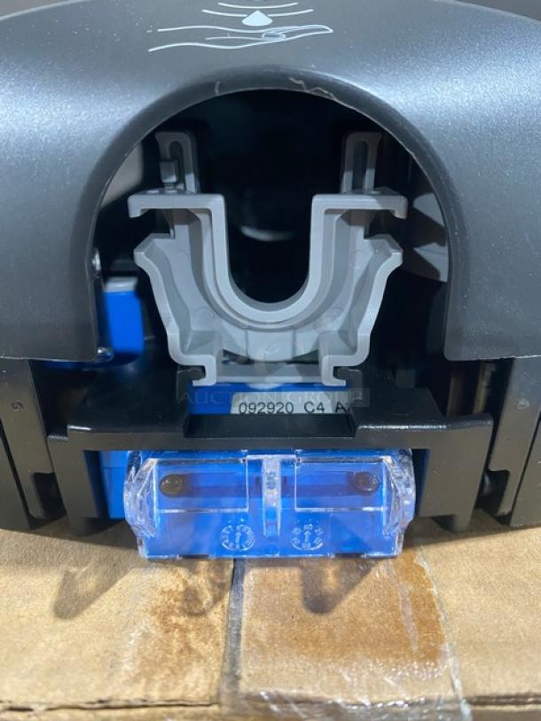 Ecolab Nexa Series touch-free dispenser, new condition, with visible serial number inside, in original packaging.