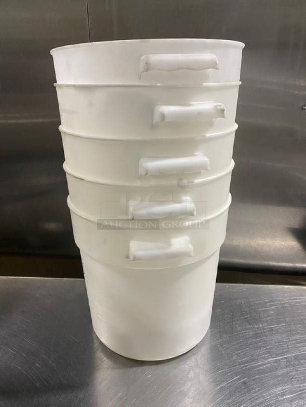White round commercial food storage containers with handles stacked, showing durable plastic material and good condition.