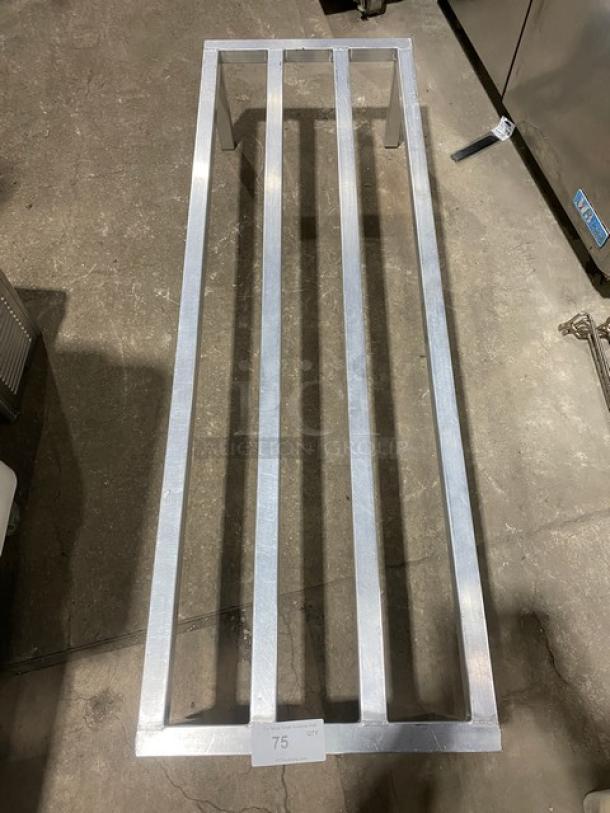 Commercial heavy-duty dunnage rack on legs, metal construction, excellent condition, label "75" visible on front.