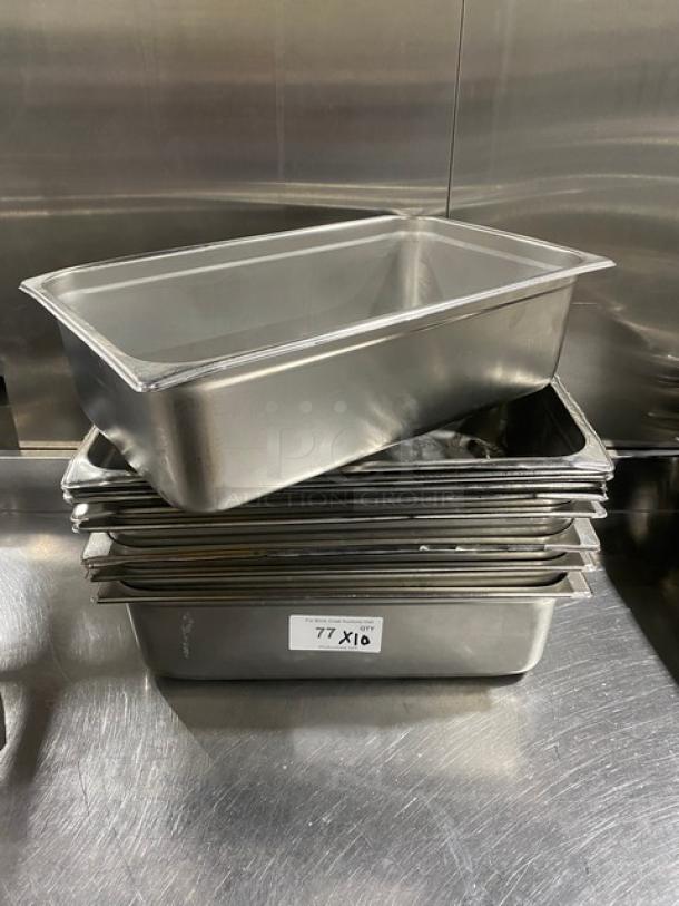 Commercial stainless steel hotel steamtable pans, stack of 10, used, with visible label "77 X10," durable and versatile.