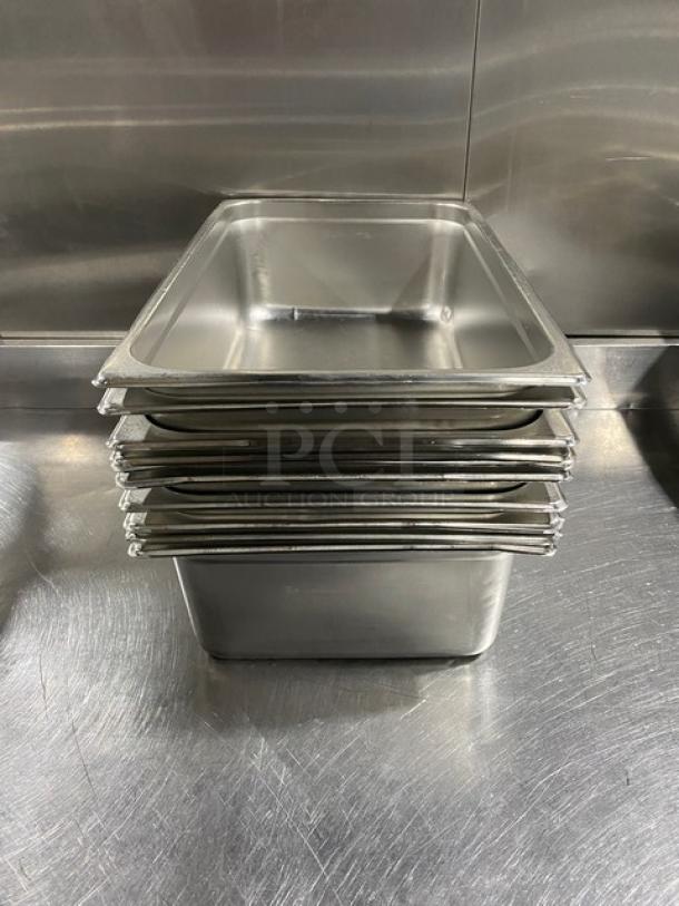 Commercial stainless steel hotel steamtable pans, stack of six, polished finish, durable, standard size, ideal for catering.