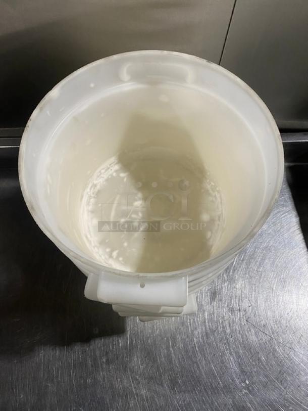 White round commercial food storage container with handles, shown open. Rugged plastic material, good condition.