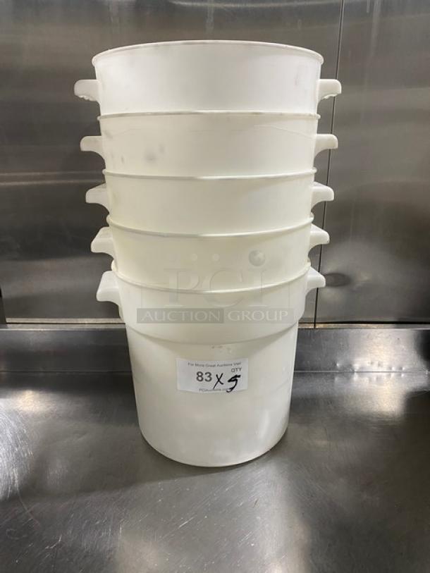 Stack of five white round commercial food storage containers with handles, slightly used. Label indicates lot number 83.