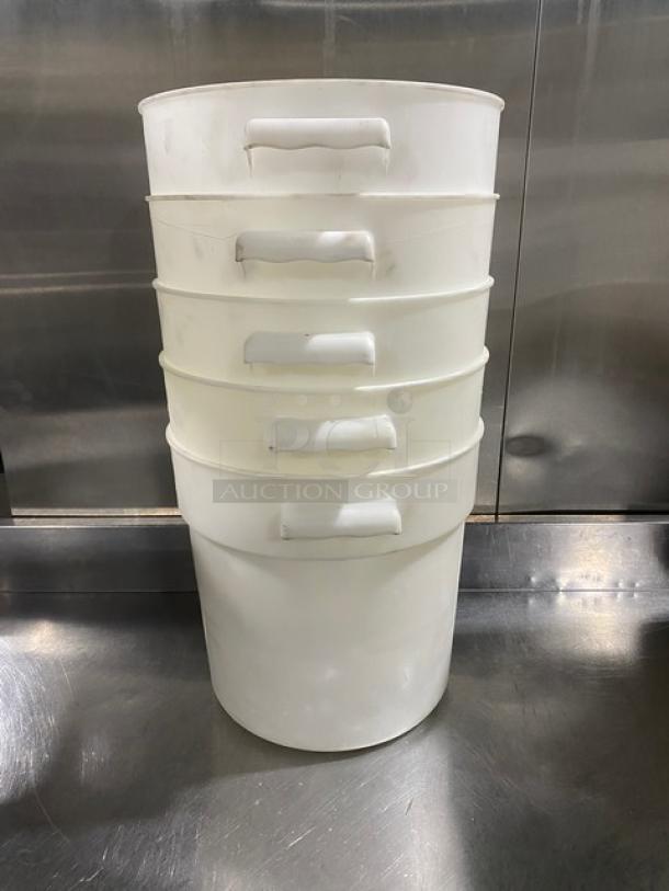 Stack of five commercial white round food storage containers with handles. Good condition. Ideal for bulk storage.