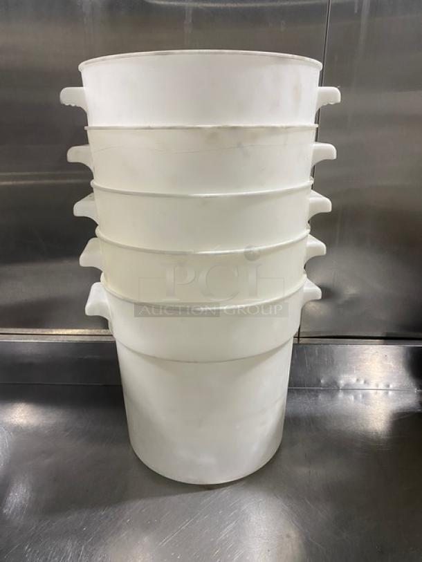 Commercial white round food storage containers with handles, stacked. Durable plastic, used condition. Ideal for bulk storage.