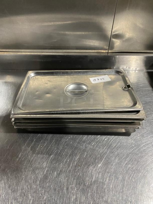 Commercial stainless steel notched hotel pan lid, set of six. Features handle, stackable design. Used condition.