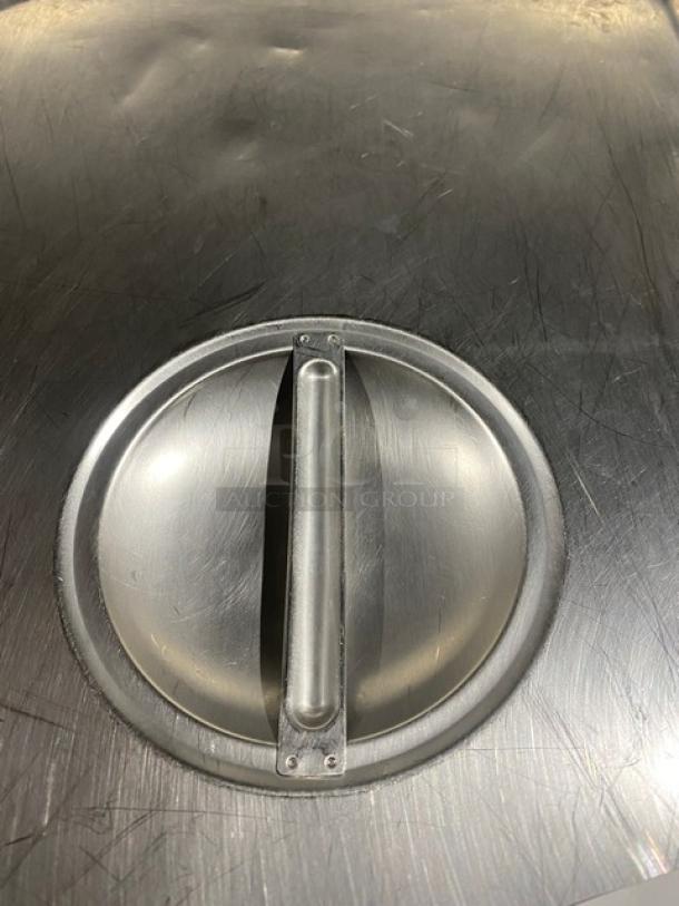 Commercial stainless steel notched hotel/steam table pan lid, used condition, with handle and notched edge.