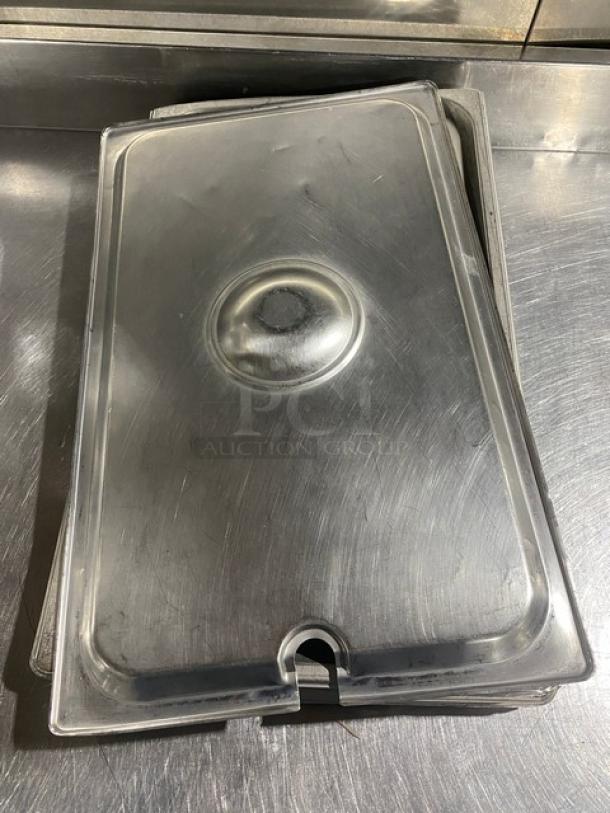 Stainless steel notched hotel pan lid, rectangular, used condition, 10"x10", visible wear, stackable design for commercial use.