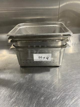 Commercial stainless steel perforated steamtable pans, stack of four, in good condition. Auction label visible on front.