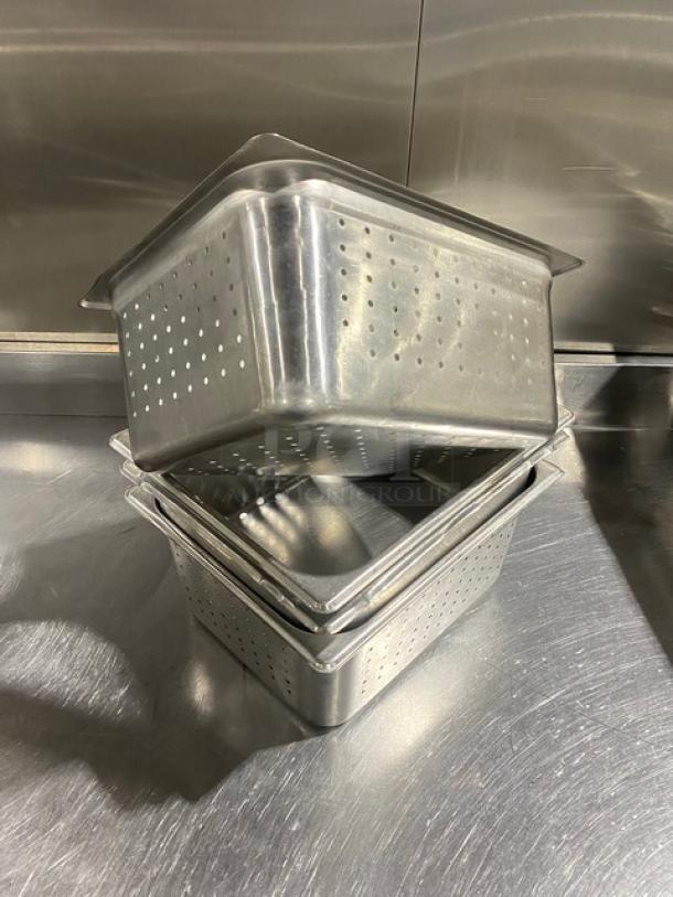 Commercial stainless steel perforated hotel steam table pans, stack of three, excellent condition, suitable for professional kitchens.