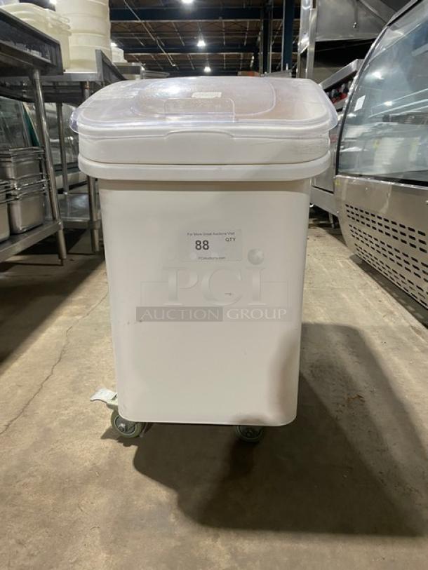 Winco commercial white portable food storage bin with clear lid on casters, tag reading "88 QTY," in good condition.