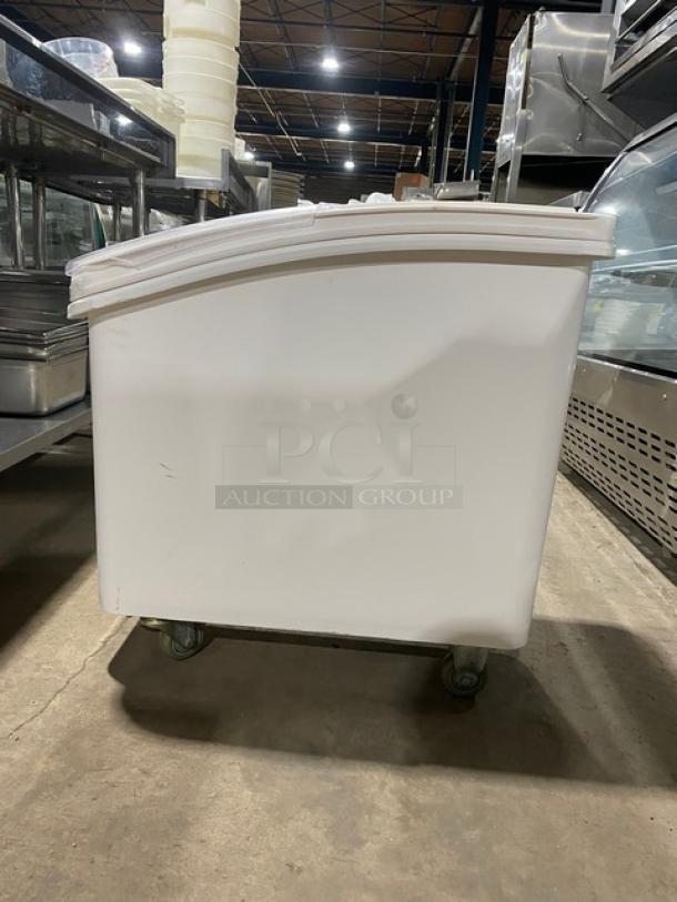 Winco commercial white portable food storage bin with clear lid, on casters, in good condition. Ideal for ingredient storage.