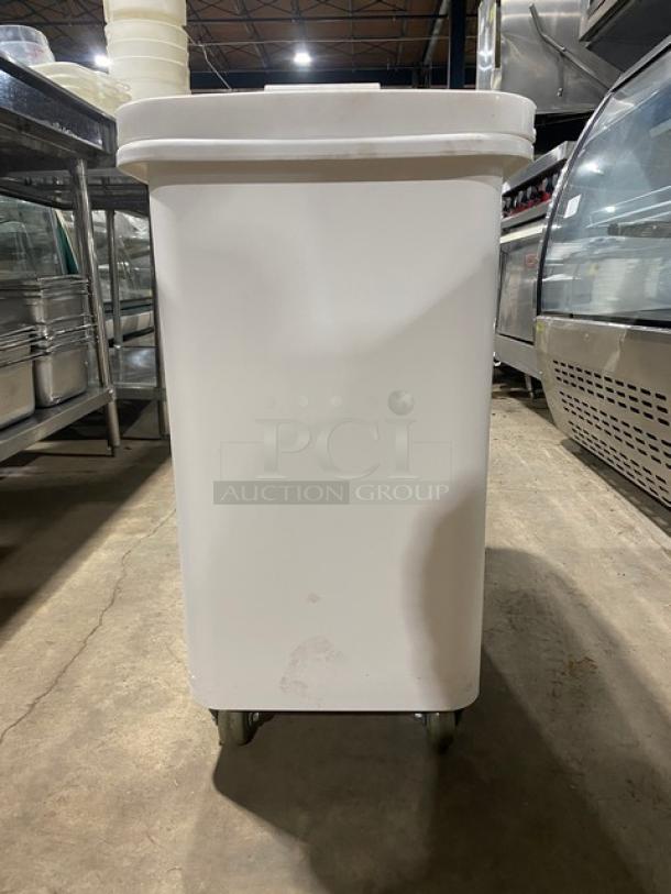 Winco commercial white portable food storage bin with clear lid, on casters. Good condition. Ideal for ingredient storage.