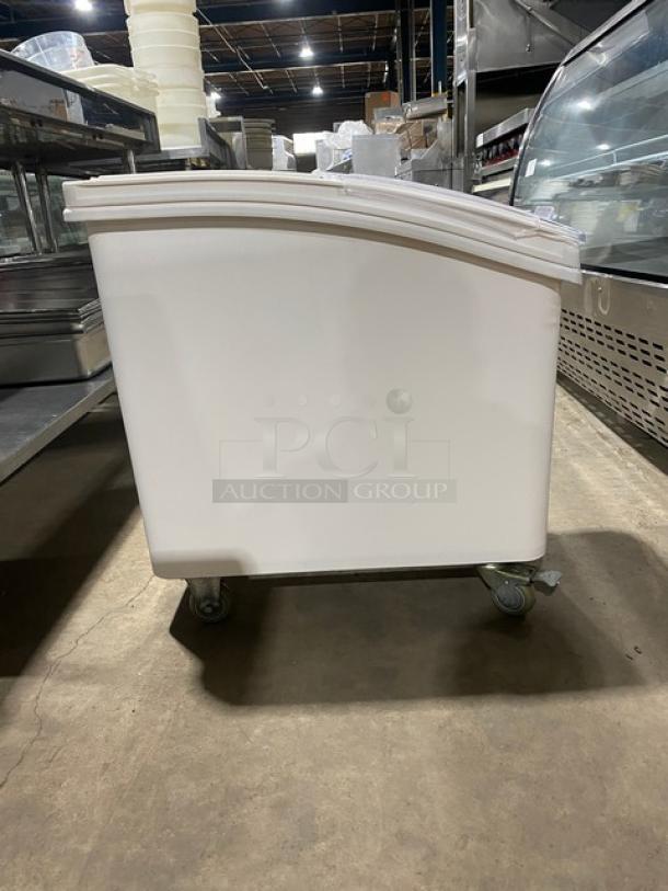 Winco commercial white portable food storage bin with clear lid and casters. Excellent condition for ingredient storage.