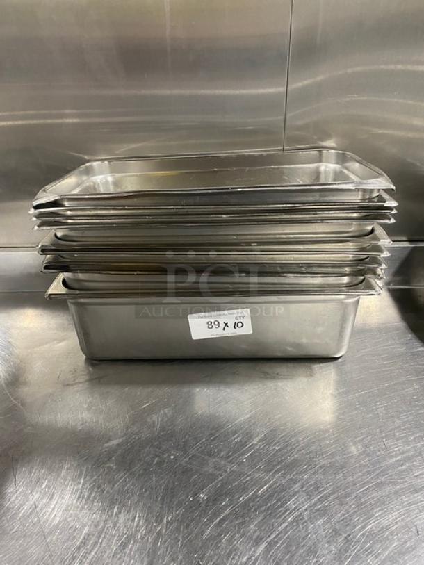 Stainless steel hotel/steamtable pans, stacked. Used condition. Pan dimensions: 10-inch. Label shows "89 x 10".