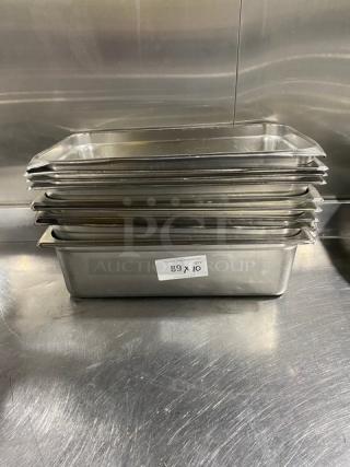 Stainless steel hotel/steamtable pans, stacked. Used condition. Pan dimensions: 10-inch. Label shows "89 x 10".