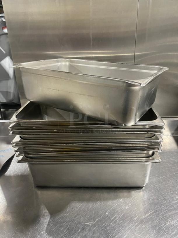 Stack of commercial stainless steel hotel steamtable pans in good condition, includes multiple pieces, for auction.