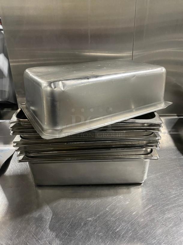 Commercial stainless steel steamtable pans, stack of five, slightly used. Rectangular, durable for hotel use.