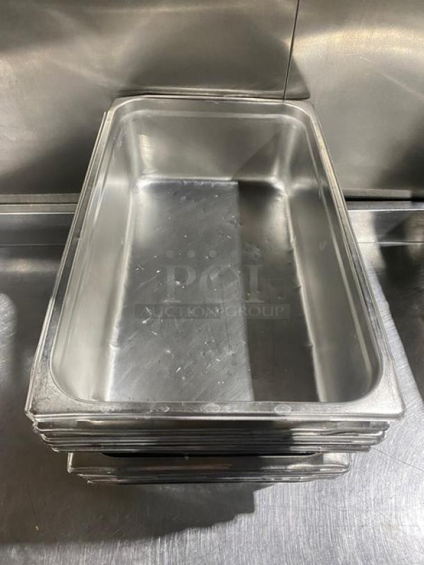 Commercial stainless steel hotel steamtable pan, stackable, used condition, showing light surface wear, sturdy design.