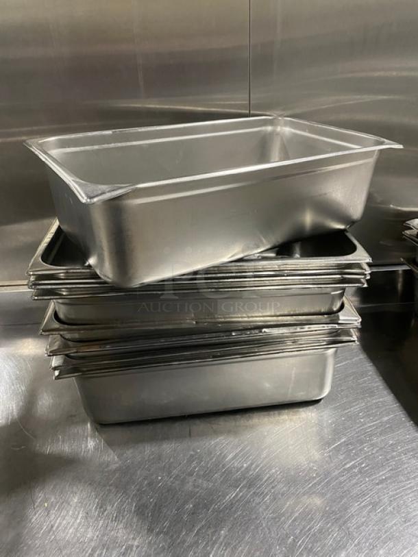 Commercial stainless steel hotel steamtable pans stacked, durable and high-quality, ideal for professional kitchen use.