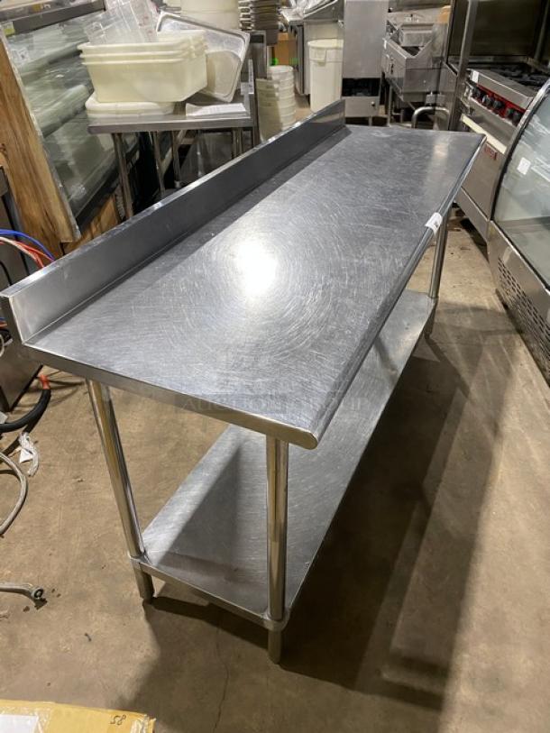 Commercial stainless steel worktop table with up-turned backsplash, single undershelf, on sturdy legs; excellent condition.