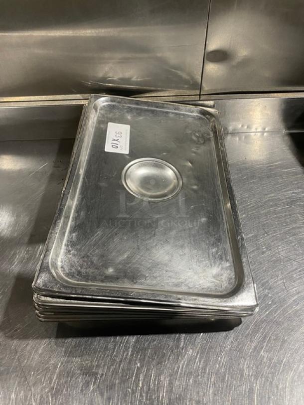 Commercial stainless steel steamtable pan lids, stack of six, rectangular with central handle indent, tagged "83 K10."