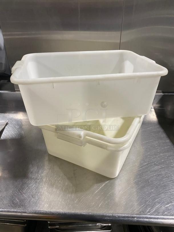 Commercial white rectangular food storage container with handles, stackable design, used condition on stainless steel surface.