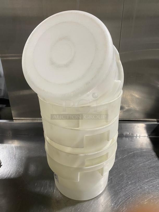 Stack of commercial white round food storage containers with handles, in good condition. Ideal for bulk storage.