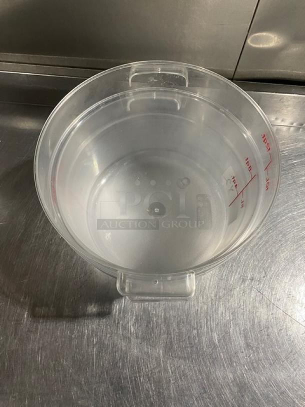 Cambro RFSCW12 clear polycarbonate 12 qt. round food storage container with handles, shown on metal surface.