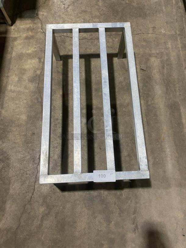 Commercial heavy-duty dunnage rack with metal slats and sturdy legs. Appears in good condition. Label reads "100 QT".