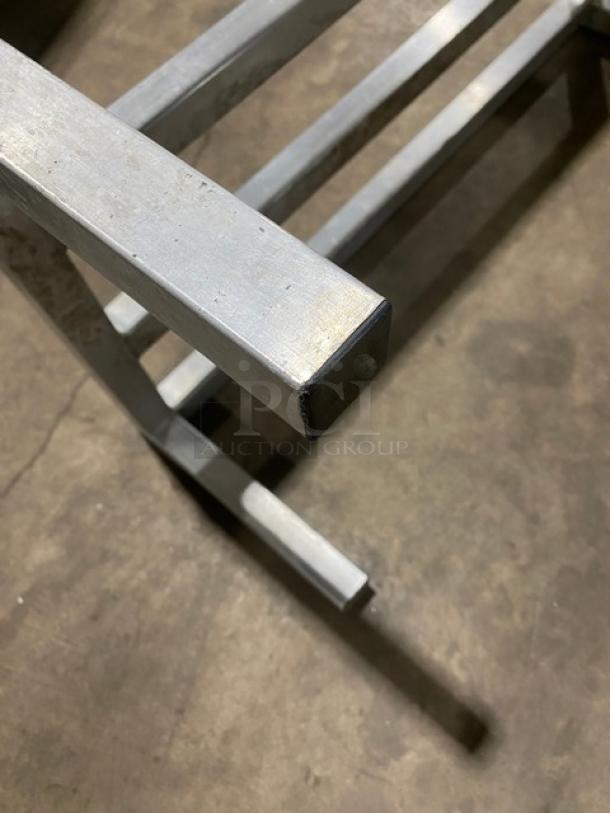 Commercial heavy-duty dunnage rack with legs, metal construction, sturdy, suitable for storage solutions.