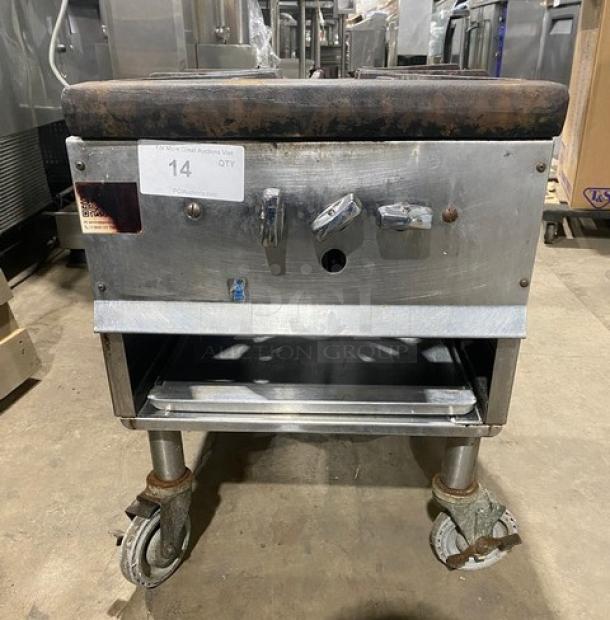 Commercial stainless steel single burner stock pot range, natural gas powered, with casters. Some wear visible.