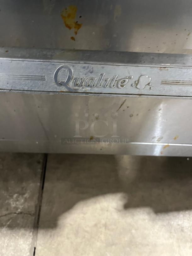 Qualite stainless steel gas 6-burner range/oven combo with backsplash, overhead salamander shelf, and wired oven rack.