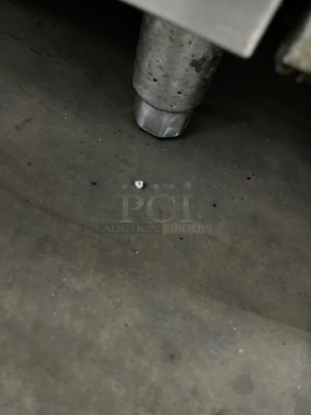 Qualite commercial stainless steel natural gas 6-burner range/oven combo with backsplash, salamander shelf, wired rack, and legs.