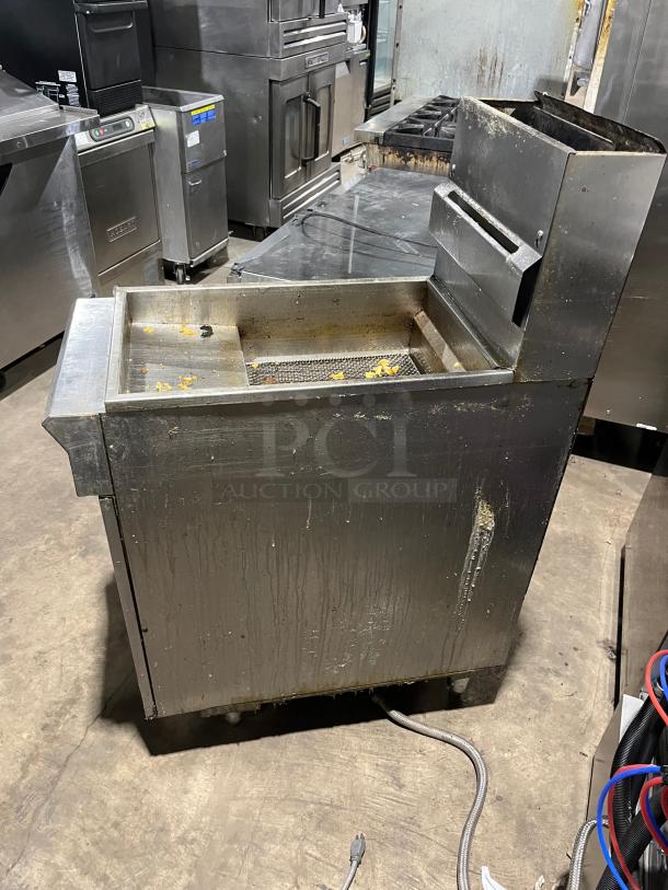 DCS commercial stainless steel natural gas deep fat fryer with backsplash, basket hanger, and legs. Used condition.