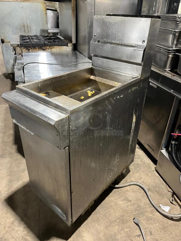 DCS stainless steel natural gas-powered deep fat fryer with back splash and basket hanger, on legs. Used condition.