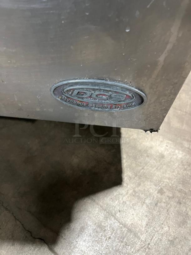 DCS stainless steel deep fat fryer with back splash, basket hanger, and legs. DCS logo visible. Natural gas powered.