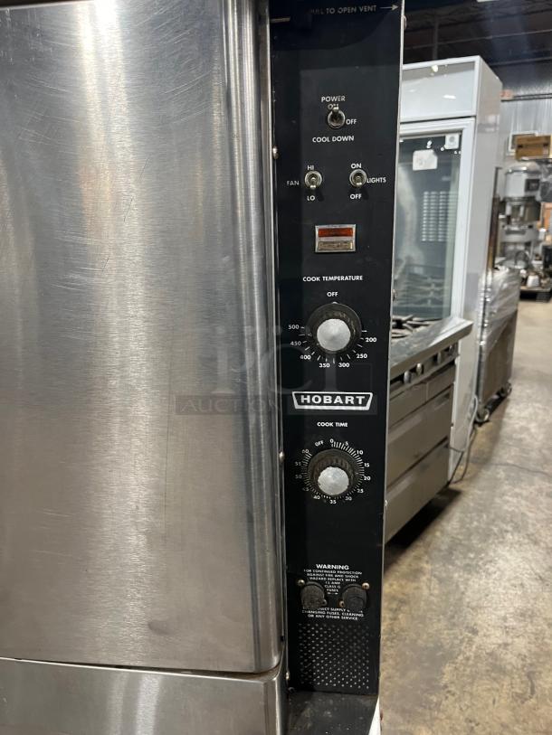 Hobart stainless steel electric double convection oven, excellent condition, on casters, with wired oven rack, visible controls.
