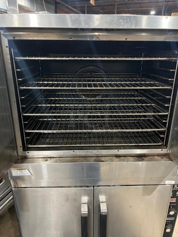 Hobart commercial stainless steel double stacked convection oven with wired rack, on casters, electric powered, used condition.